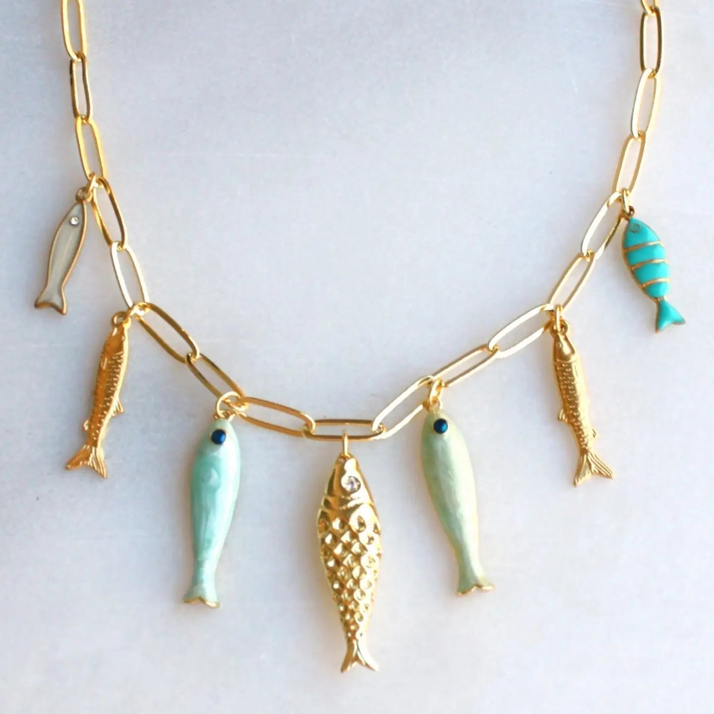 Desert Tide Necklace – Gold Chain with Playful Fish Charms
